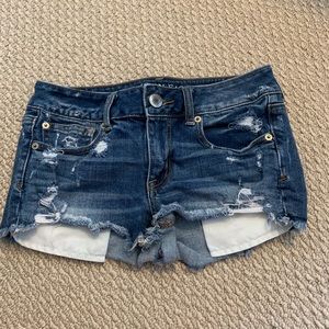 Distressed blue jean shorts.